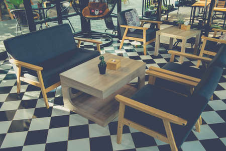 Industrial bar style,interior of cafe there are wooden tables with chairs and sofasの写真素材