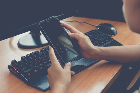 Businessman are using computers to working at home and using smart phone for social media...