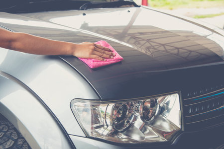 A wipe clean the car with cloth and polishing waxing cream,vintage toneの写真素材
