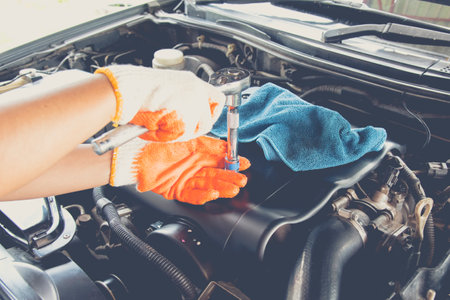 Car mechanic using the torque wrench to repairing in car engine room. Car Maintenance and repair concept.の写真素材