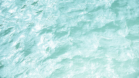 Abstract summer banner background blue clear water waves surface in sunlight with copy space for cosmetic ,moisturizer, micellar toner ,emulsion and etc.の写真素材