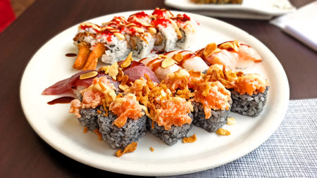 Sushi rolls on a plate on a wooden table in a restaurantの写真素材