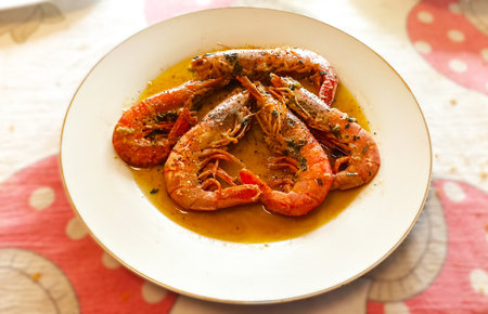 Shrimps with herbs and spices in a plate on a tableの写真素材