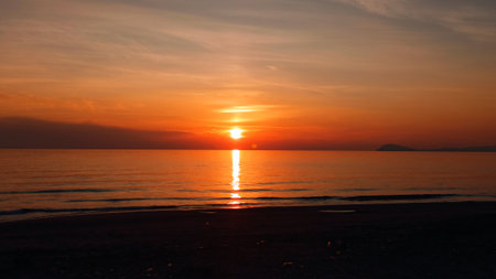Beautiful sunset on the beach. Silhouette of the sun.の写真素材