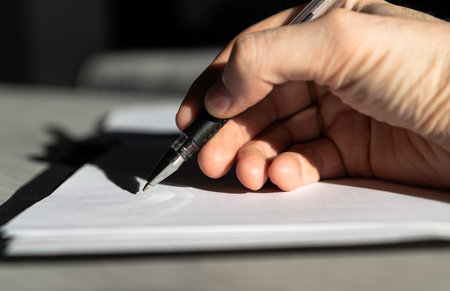 Caucasian hand silhouette about to sign important documents or contracts