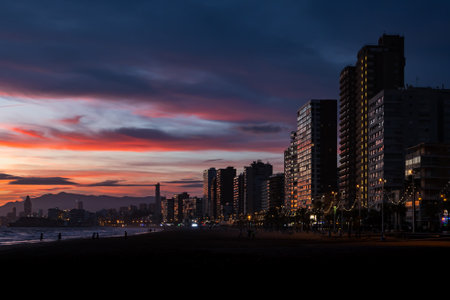 View of the skyline at sunset in winter from the promenade beach of Benidorm on the Costa Blanca, Alicante, Spain.の写真素材