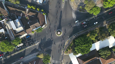 Aerial View of a Bustling City Intersection with Traffic and Greenery
