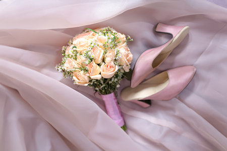 Elegant Bridal Bouquet and Pink Wedding Shoes on Soft Fabricの写真素材