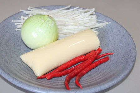 Asian Cooking Ingredients - Tofu, Chili, Enoki Mushrooms, and Onion
