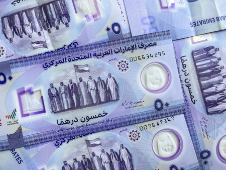 Closeup of new UAE 50 dirhams currency notes, paper money, against white background, released on Dec, 2021 to mark Golden jubilee. Finance and Economy concepts.の写真素材