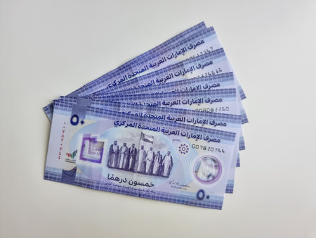 Closeup of new UAE 50 dirhams currency notes, paper money, spread on white background, released on Dec, 2021 to mark Golden jubilee. Finance and Economy concepts.の写真素材