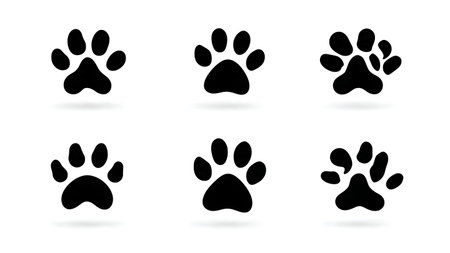 Negative Space Paw Print Silhouette Icon Set isolated on plain white background.のイラスト素材