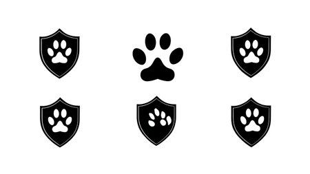 Paw Print Shield and Crest Logo Silhouette Set isolated on plain white background.のイラスト素材