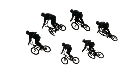 Worm's-Eye View of BMX Rider Jump Silhouettes isolated on plain white background.