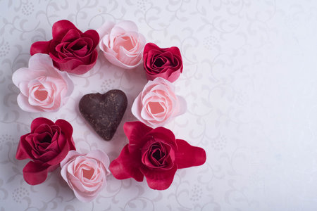 heart shape sweet in middle of roses