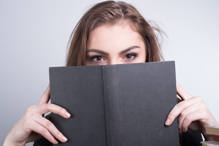 girl looking over the book