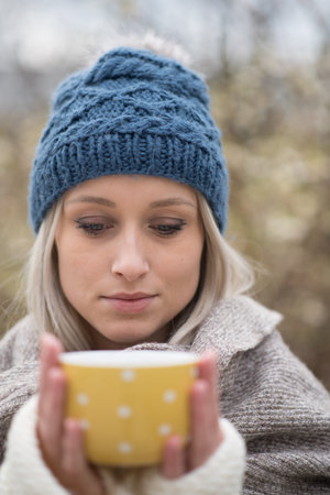 girl looking at yellow cupの写真素材