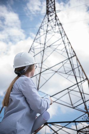 woman engineer looking at power line