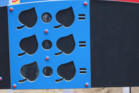 An educational board in the playground for children allows counting.