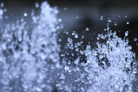 Drops of water in the fountain in summer
