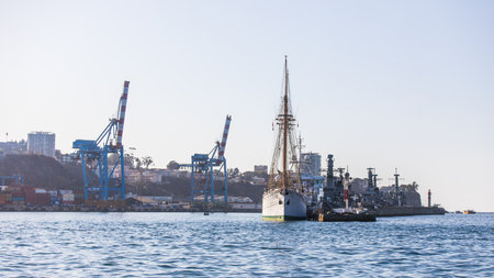 A large sailing ship moored in front of large cranes in the cargo port of Valparaiso in Chile.の写真素材