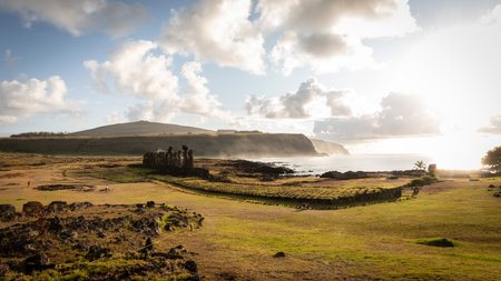 The 15 moais of Ahu Tongariki on Rapa Nui glow in a golden light during sunrise.の写真素材