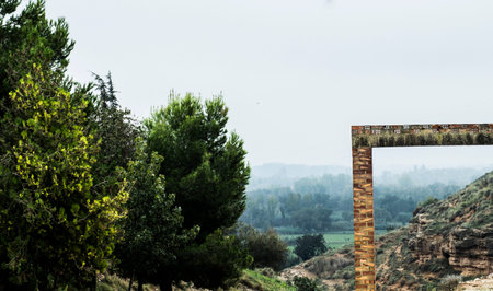 curious natural landscape with niewbla in the background and a built brick frameの写真素材