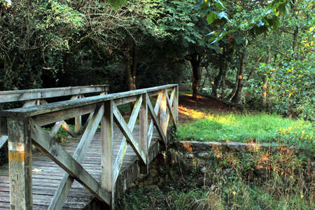 Wooden bridge over the Pedras River. Beginning of a path through the woods of Puebla del CaramiÃ±al (CoruÃ±a), following the course of the river.の写真素材