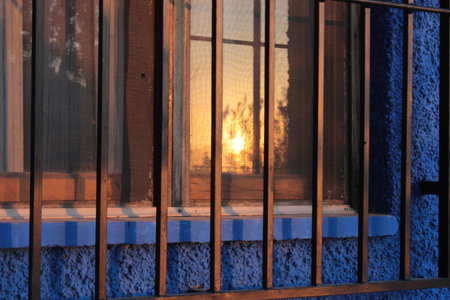 Reflections of the sunset in the window of a traditional house in the Murcian orchardの写真素材