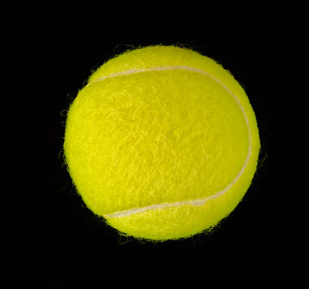 New tennis ball isolated on black backgroundの写真素材