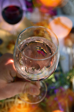 wine glass filled with white wine in a colorful spring mood