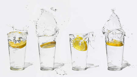 glass of clear water with a splash of lemonの写真素材