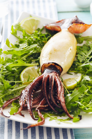 Grilled squid with rocket salad and lemon