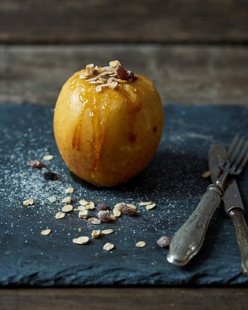 baked apple with caramellized sugar, cereal and racinの写真素材