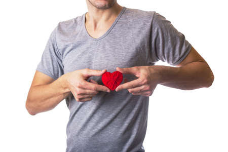 Man holding red wool heart. White isolatedの写真素材
