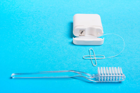 Toothbrush and dental floss should be used togetherの写真素材
