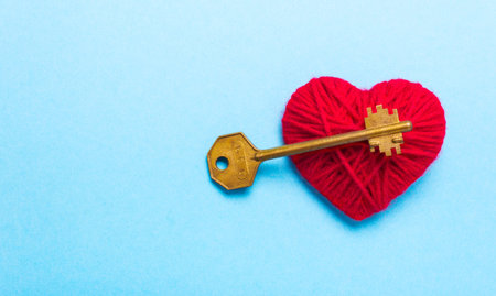 Golden Key to a red heart on a blue background. Love Valentines Dayの写真素材