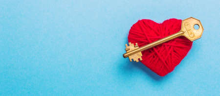 Golden Key to a red heart on a blue background. Love Valentines Dayの写真素材