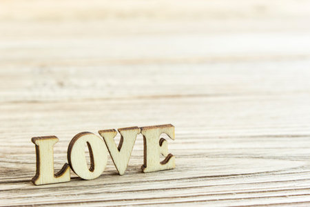 Close-up word love from carved wooden letters on the boardsの写真素材