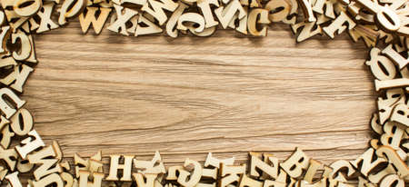 Frame made of letters of the alphabet made of wood with empty space for textの写真素材