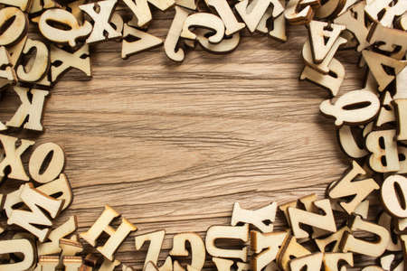 Frame made of letters of the alphabet made of wood with empty space for textの写真素材