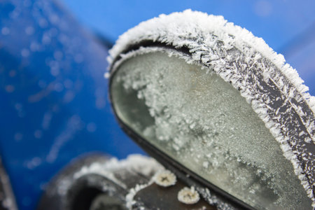 Mirror blue car in frost and snow in the winter