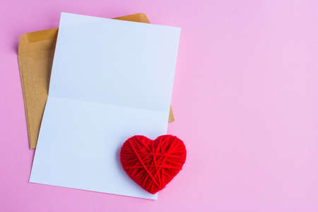 Love letter with red hearts on a pink background, empty letterの写真素材