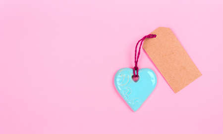 blue heart with empty tag on a pink backgroundの写真素材