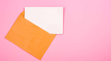 empty postcard and envelope on a pink backgroundの写真素材