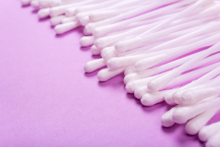 closeup clean ear sticks on violet background slide