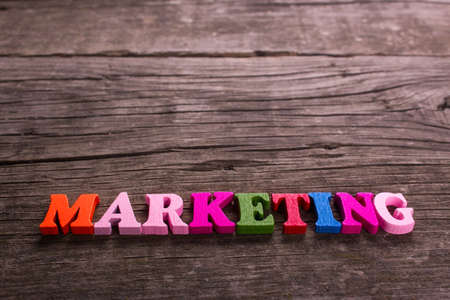 marketing word made from colored wooden letters on an old table. Conceptの写真素材