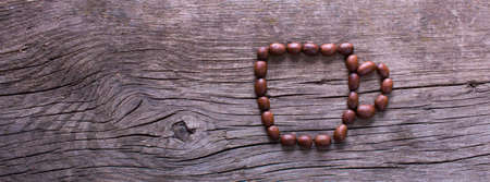 cup symbol from coffee beans on old wooden tableの写真素材