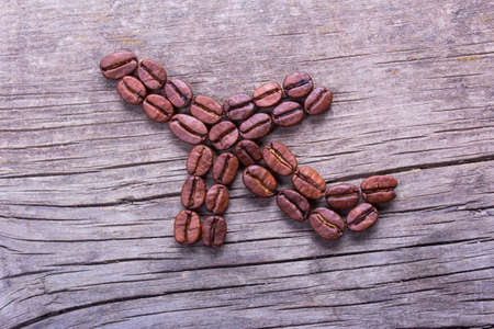 Aircraft or Airplane from coffee beans on old wooden tableの写真素材