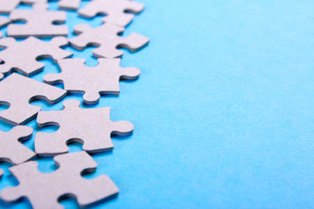 Puzzle pieces with empty space for text on a blue backgroundの写真素材